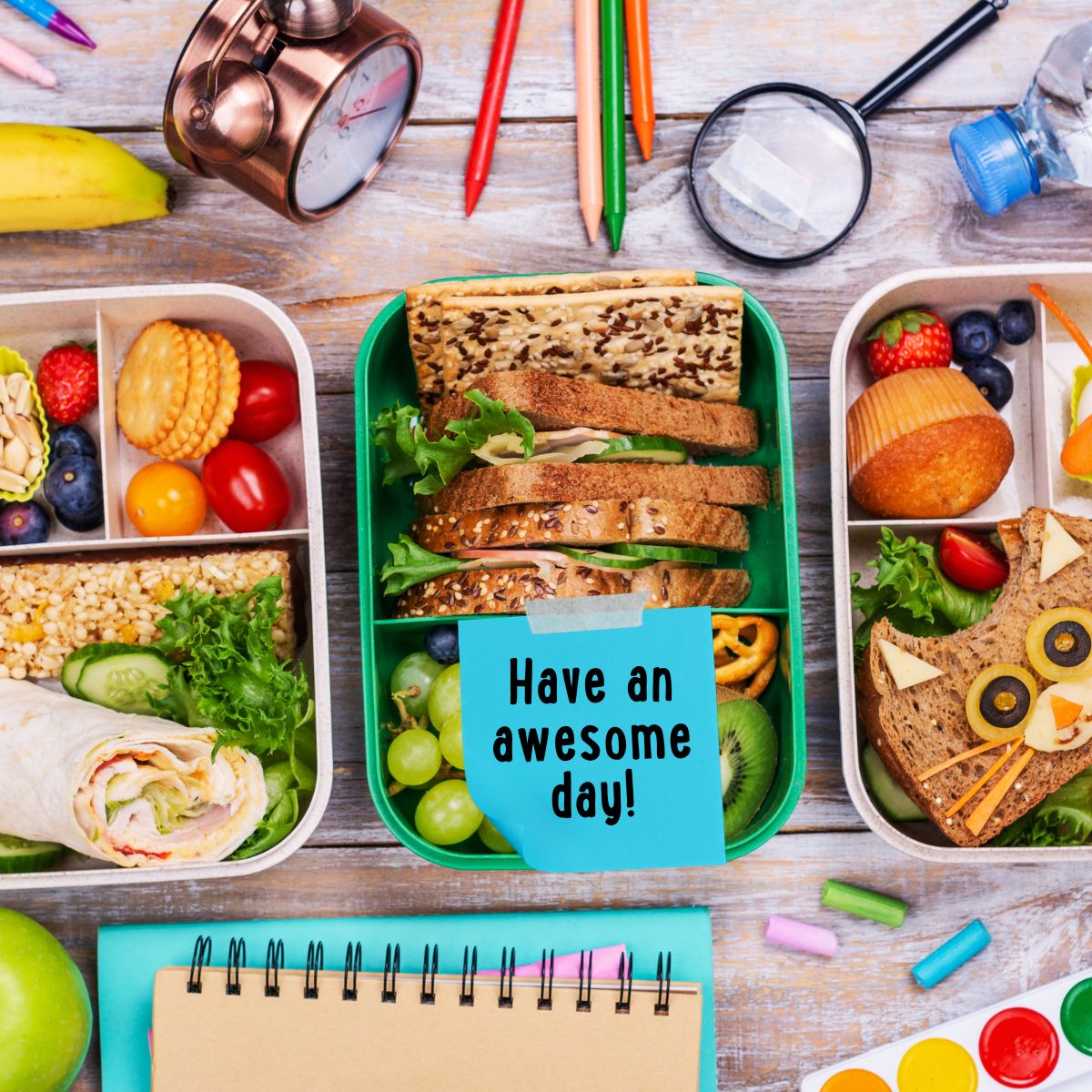 Kids lunches packed in bento style boxes. Middle box has a blue lunchbox note on it that says Have an awesome day!