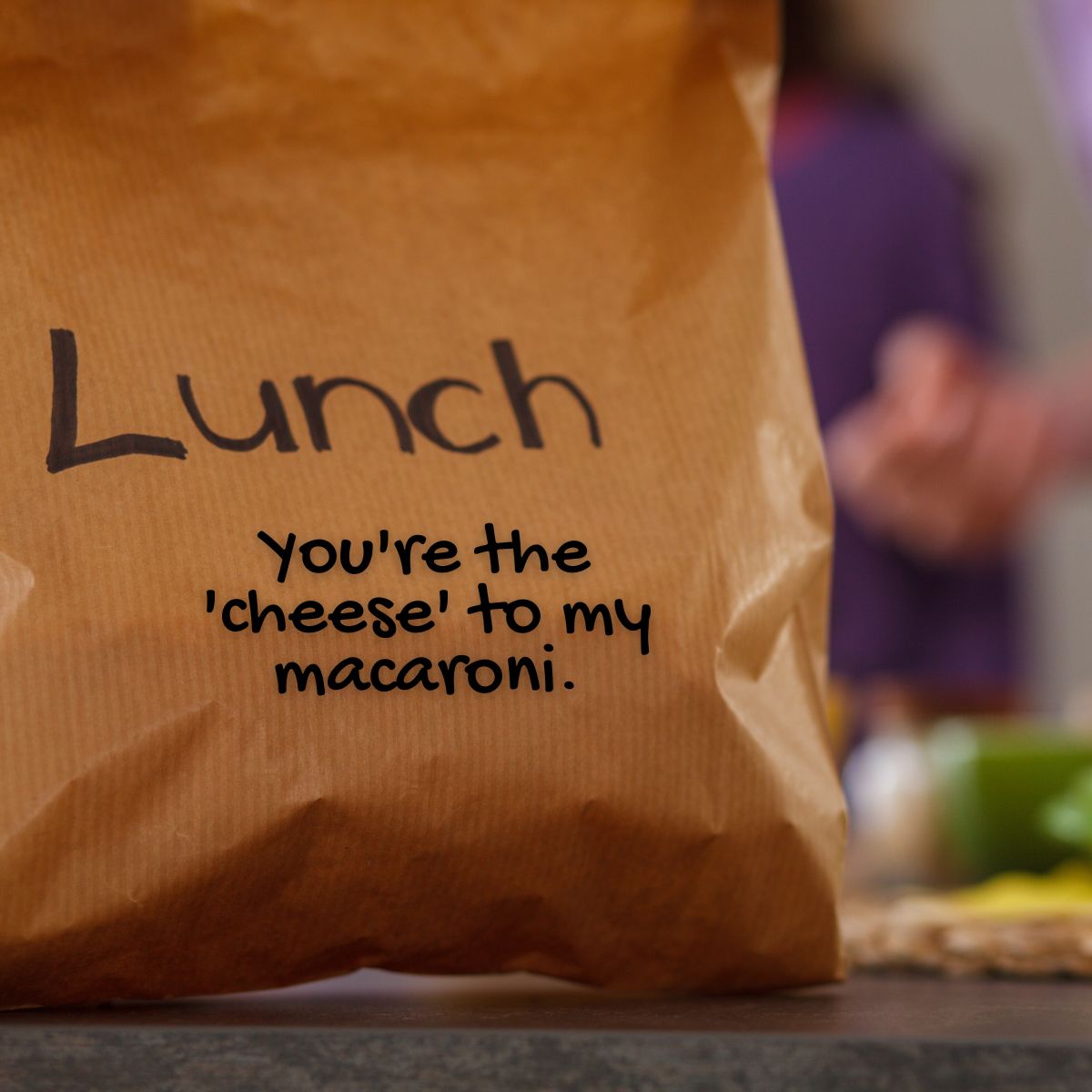 Brown paper lunch bag with a note written on it that says "You're the cheese to my macaroni."