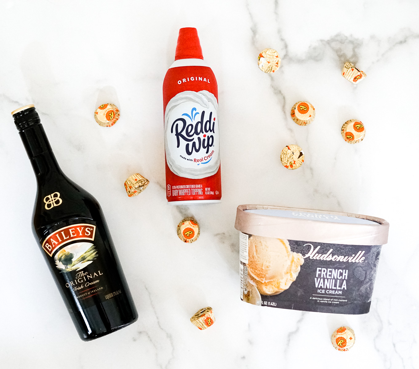 Bailey's Irish Cream, Vanilla Ice Cream, Reese's Peanut Butter Cups and whipped cream - the ingredients for a Bailey's Irish Cream and Reese's Peanut Butter Cup Milkshake.