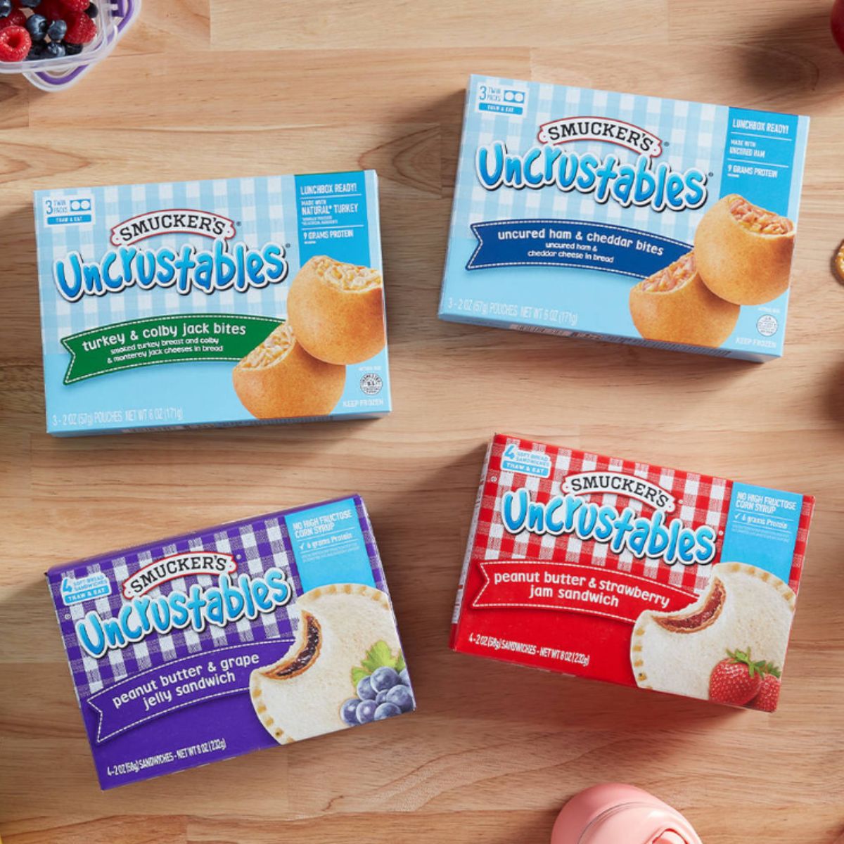 Four boxes of uncrustables on top of a kitchen counter.