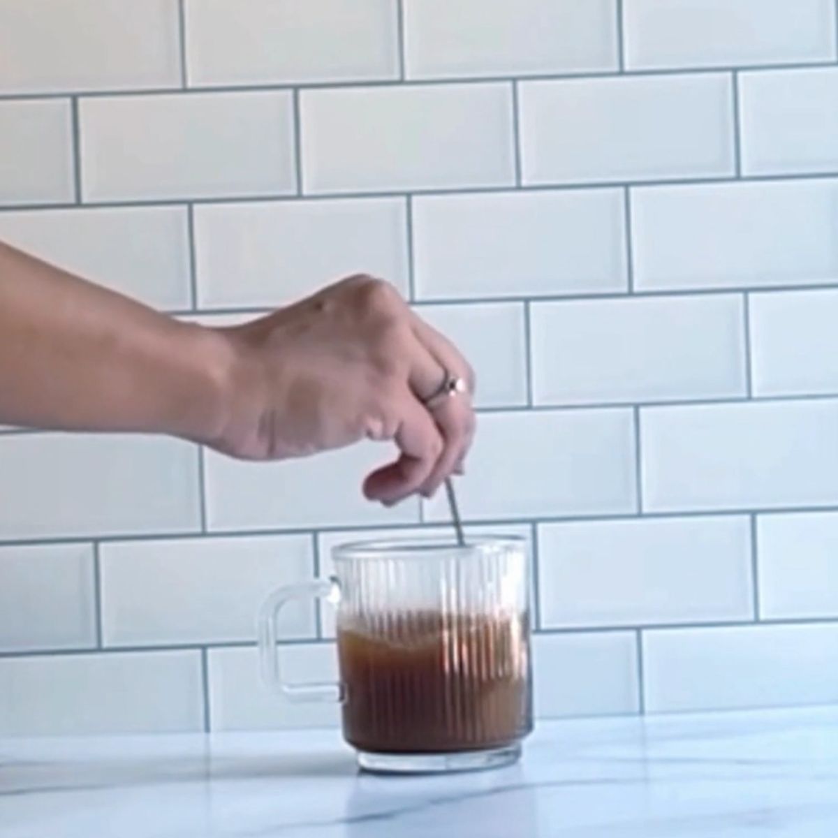 Stirring simple syrup and coffee together