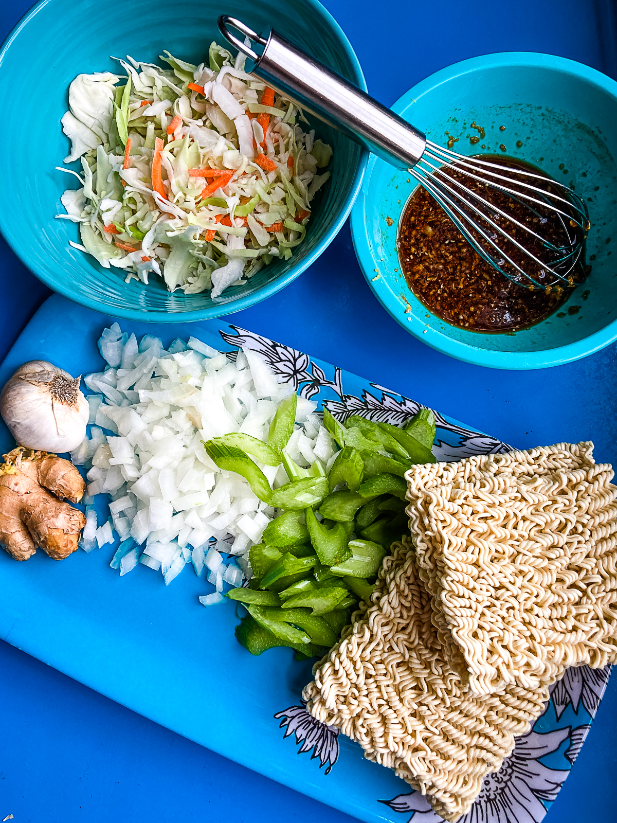 Ingredients for Chow Mein on a turquoise table
