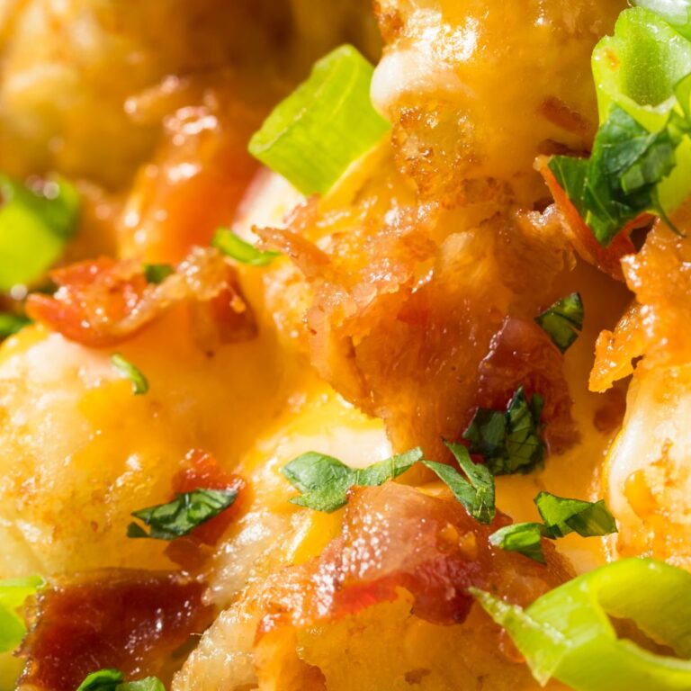 Cheesy Chicken Bacon Ranch Tater Tot Crockpot Casserole topped with green onions and parsley