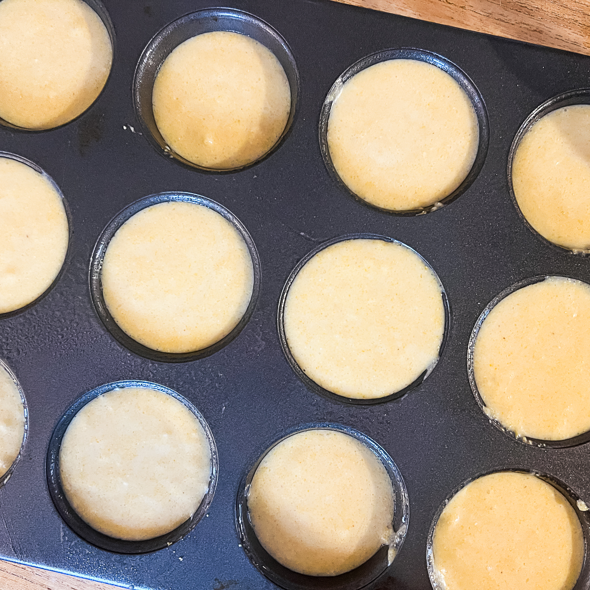 Cracker Barrel Cornbread Muffins Copycat Recipe - Step 4 - put cornbread batter in muffin tins before putting in oven