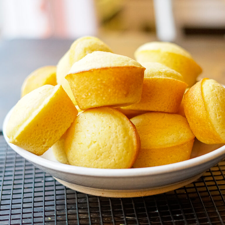 Cracker Barrel Cornbread Muffins Copycat Recipe stacked in a shallow bowl on a wire rack