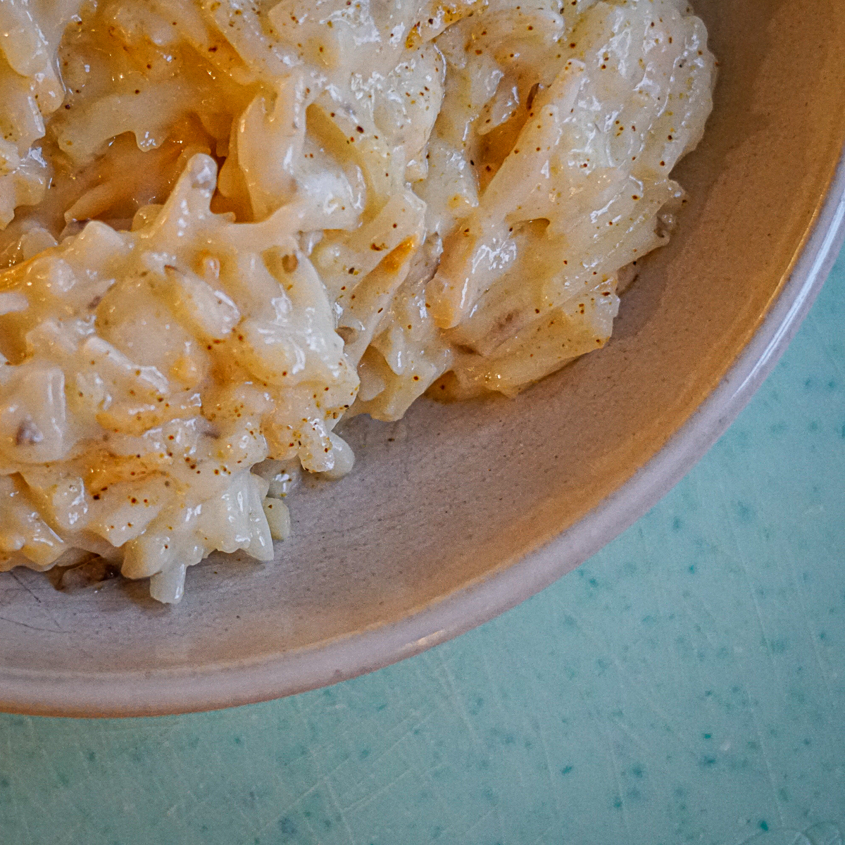 Cracker Barrel Copycat Dairy Free Cheesy Potatoes in a bowl with seasoning