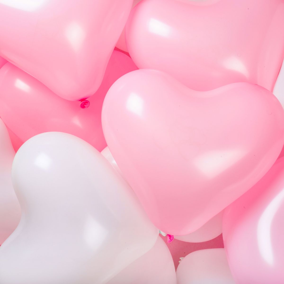 heart shaped balloons in pink and white