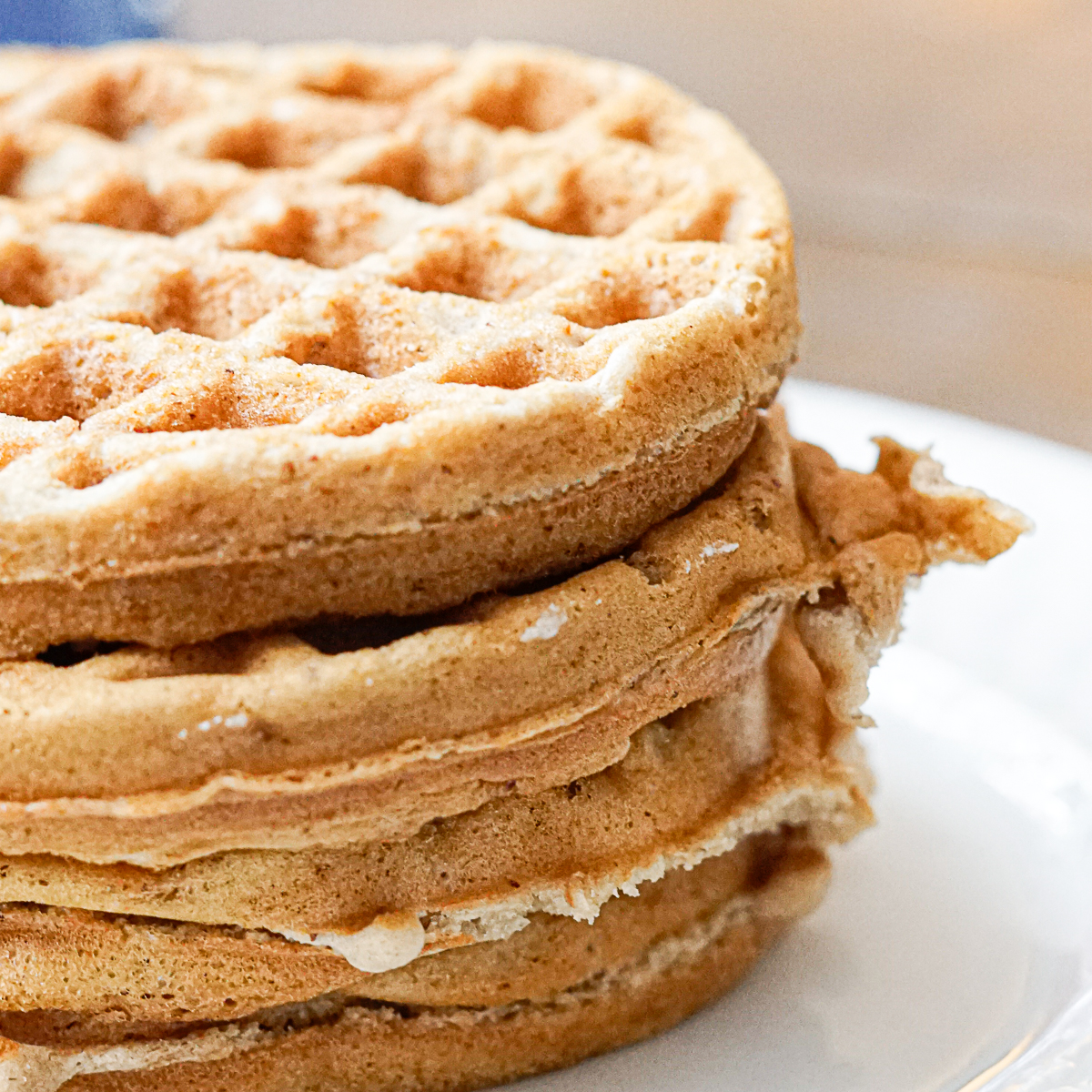 Stack fo banana bread waffles on a white plate