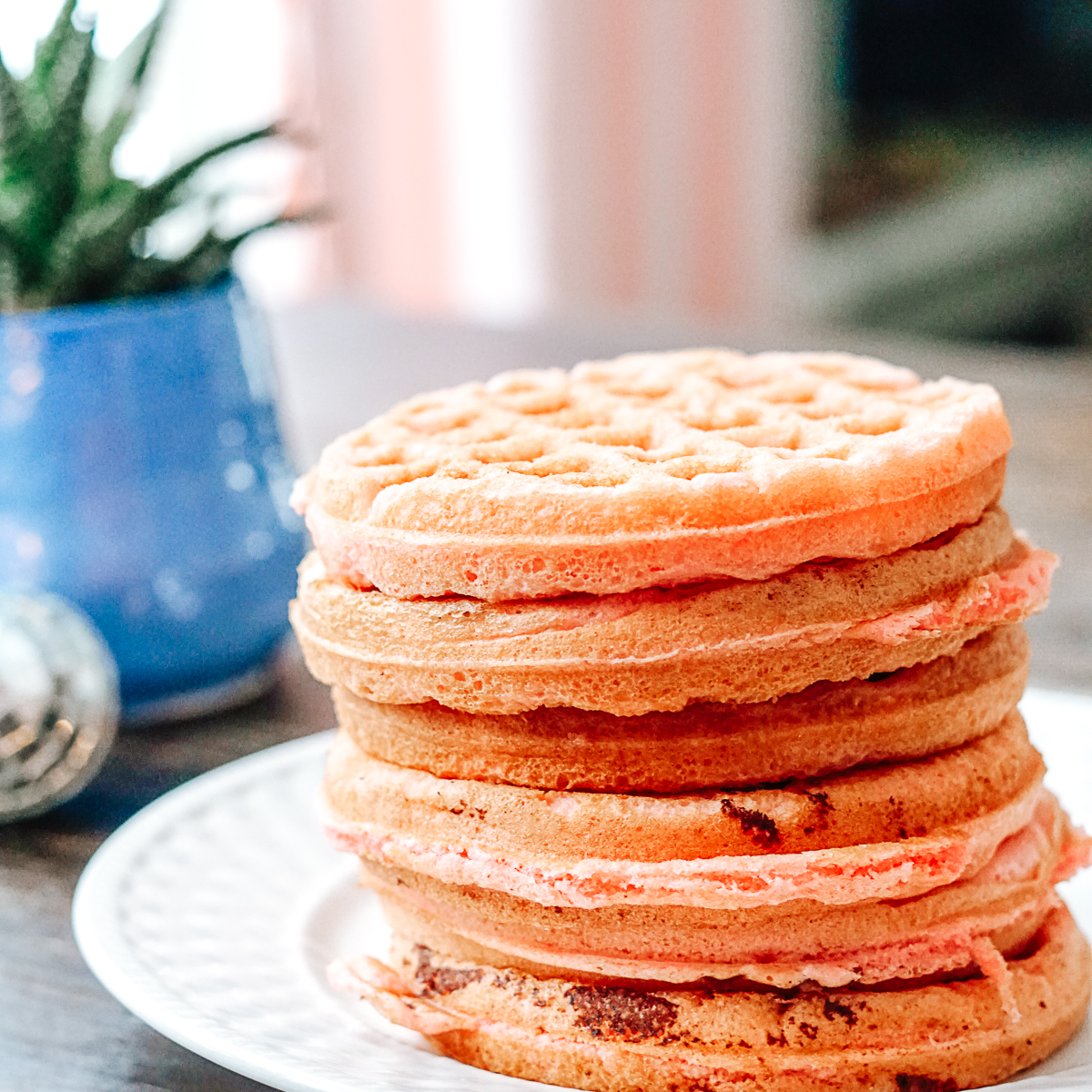 Stack of Strawberry Cake Waffles on a white plate
