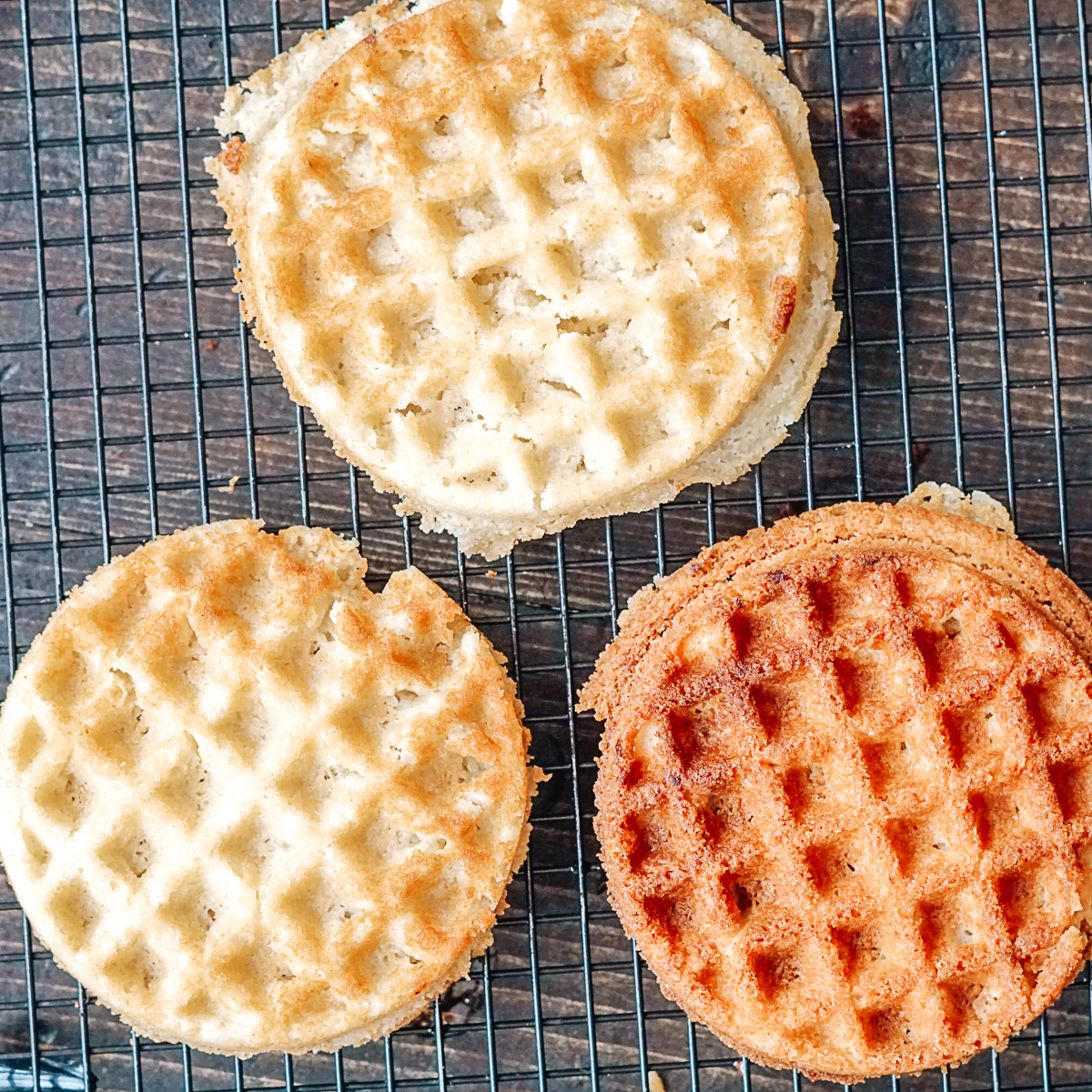 Light and dark sugar cookie waffles on a cooling rack